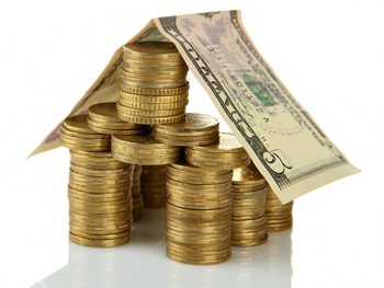 Coins house isolated on white